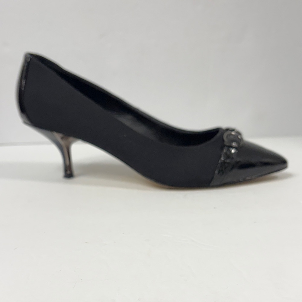 Donald J Pliner feature a pointed cap toe and a buckled vamp strap